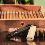 many cigars inside of a big wooden cigar box