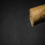 The end of an open cigar against a black background