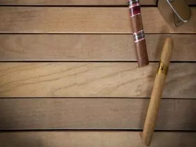 Wood backdrop with two cigars sitting on it
