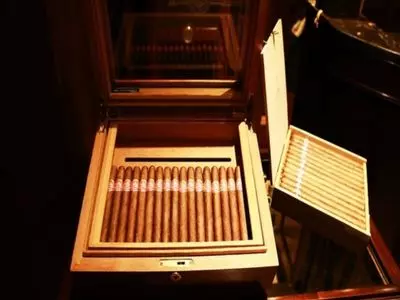 A cigar humidor with many cigars inside
