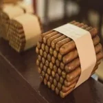 A large amount of cigars sitting together in a wrapper